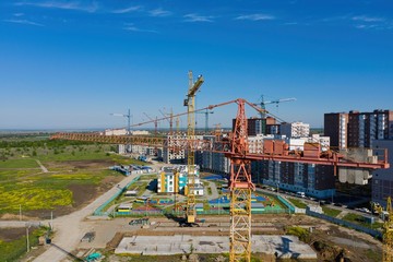 Fototapeta na wymiar Building crane and building under construction. Construction site. Aerial view.