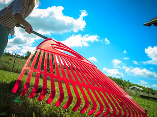 Unusual angle of woman raking leaves