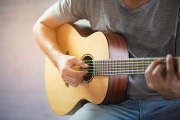 Fototapeta na wymiar musician man playing acoustic guitar