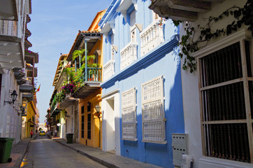Walking the narrow and colorful streets with historic old buildings with wooden balconies and urban...