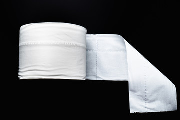 toilet paper isolated on black