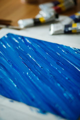
Beautiful blue and white stripes on canvas. Acrylic paints with a thick stand applied to the canvas, a beautiful abstract painting with paints