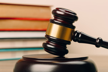 Judge gavel and laws books on a wooden table.