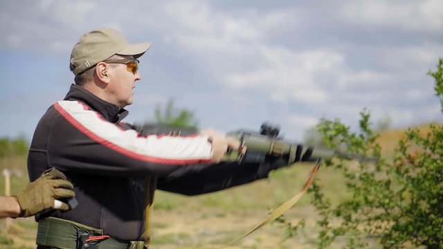 A man shoots from a bolt rifle. Shooter training. Soft focus