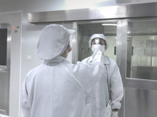 blur image of factory worker standing checking temperature before go to working area. Clean...