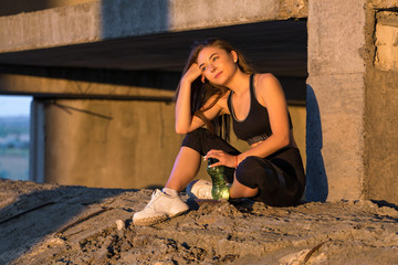 A young slim athletic girl in sportswear with snakeskin prints performs a set of exercises. Fitness...