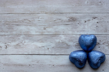 Valentine's candies in the shape of a heart on a tree background. Concept Of Father's Day