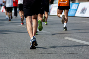 Fototapeta premium Running feet leave traces on the asphalt. 