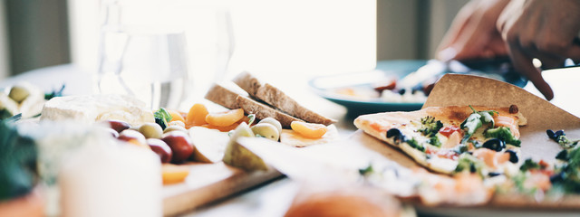 Lots of tasty and delicious food on the table. Dinner at home for romantic couple. Close-up focus. Wide screen panoramic