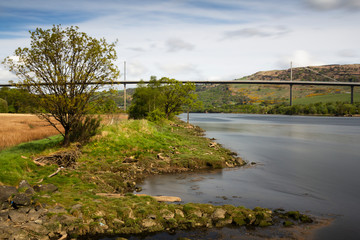 Fototapeta na wymiar The Erskine Bridge over the river Clyde in the west of Scotland on a clear spring morning. 