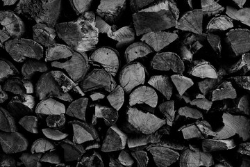 Dry chopped firewood logs ready for winter as background or texture.