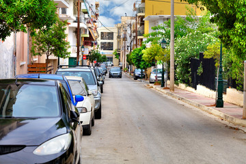 Deserted old one-way street in Loutraki, Greece, on an early summer morning.