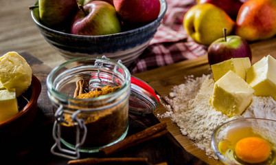 Baking apple pie ingredients with fresh apples, butter and cinamon, close-up photo