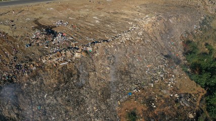 Aerial view of dump landfill site, large garbage, waste from household on mountain. Ecological problem of pollution.
