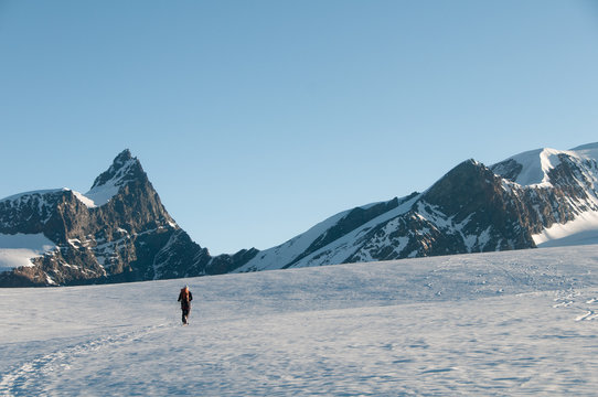 An alpinist going through Gornergletscher glacier near Zermatt, direction to Adlerpass, between Rimpfischhorn and Strahlhorn, Switzerland, Alps, Europe