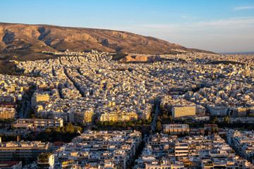 Panoramic sunset view of metropolitan Athens, Greece, with Hymettus forested mountain in background...