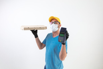 Delivery guy with protective mask holding pizza box and POS for contactless payment.