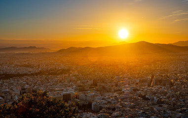 Panoramic sunset view of metropolitan Athens, Greece, with Mount Aigaleo in background seen from...