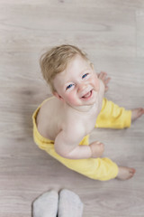 Fototapeta premium beautiful baby in the room is playing with mom, a red-cheeked child.