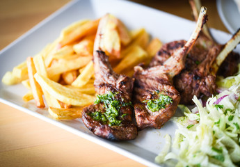 delicious grilled lamb chopsticks with french fries, pesto sauce & mix of lettuces