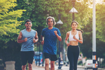 Runners. Young people  running on a city path
