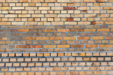Old brick wall frontal with different stones.