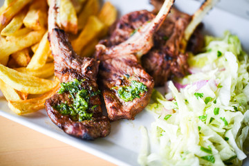 delicious grilled lamb chopsticks with french fries, pesto sauce & mix of lettuces