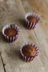 chocolate muffins on a wooden table