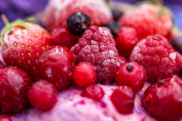 Close up of frozen berries on a cyan background. Cold summer fruit close-up.
