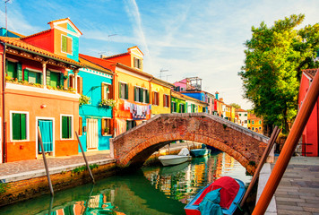 Fototapeta na wymiar Colorful houses in Burano island near Venice, Italy. Canals and streets of Burano.