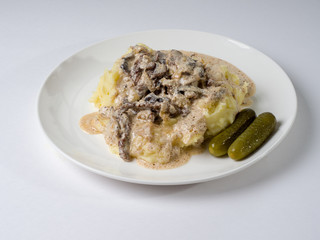Beef stroganoff with crushed potatoes on a plate. Tasty healthy food