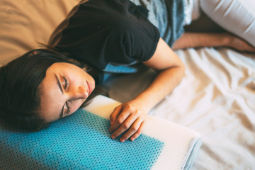 Woman sleeping on an ergonomic pillow. Ergonomic and comfortable pillow Concept.