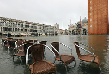 Chairs of an alfresco cafe in the fully flooded Square of Saint