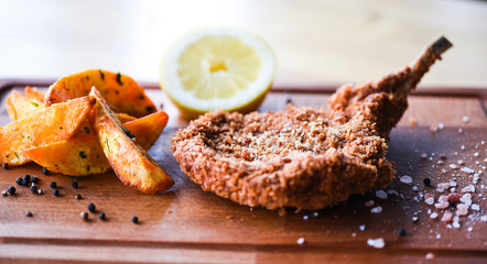 delicious crispy panko pork schnitzel with wedges & fresh pepper