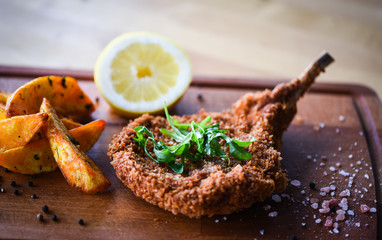 delicious crispy panko pork schnitzel with wedges & fresh pepper