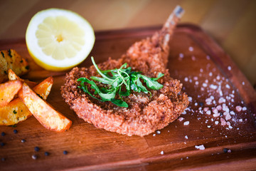 delicious crispy panko pork schnitzel with wedges & fresh pepper
