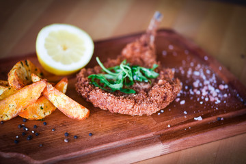 delicious crispy panko pork schnitzel with wedges & fresh pepper