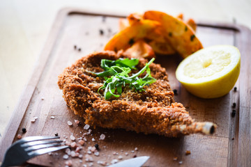 delicious crispy panko pork schnitzel with wedges & fresh pepper