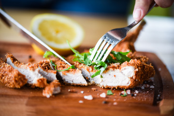 delicious crispy panko pork schnitzel with wedges & fresh pepper