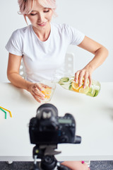 Asian woman pouring fresh water into a cup