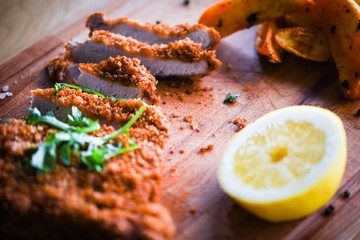 delicious crispy panko pork schnitzel with wedges & fresh pepper