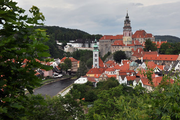 Panorama of the high walls and towers of the castle, St. Vitus Church and the bend of the Vltava River in the historic part of Cesky Krumlov. View from the seminary park.