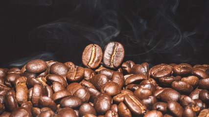Coffee beans roasted on a black background with copy space for your text