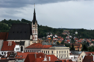 Panorama of tiled roofs of houses in the historic city of Cesky Krumlov. View of the St. Vitus Church.