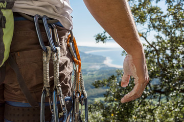 Climber with a bunch of carabiners. Landscape background. Climbing day.