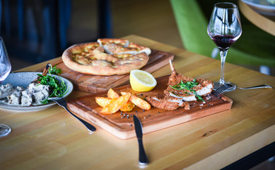 delicious crispy panko pork schnitzel with wedges & fresh pepper