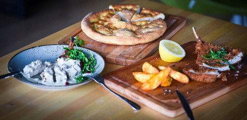 delicious crispy panko pork schnitzel with wedges & fresh pepper