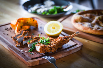 delicious crispy panko pork schnitzel with wedges & fresh pepper