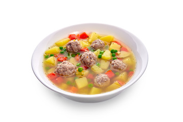 Meatballs with green peas in the potato soup