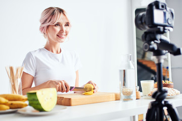 Woman recording cooking process on camera